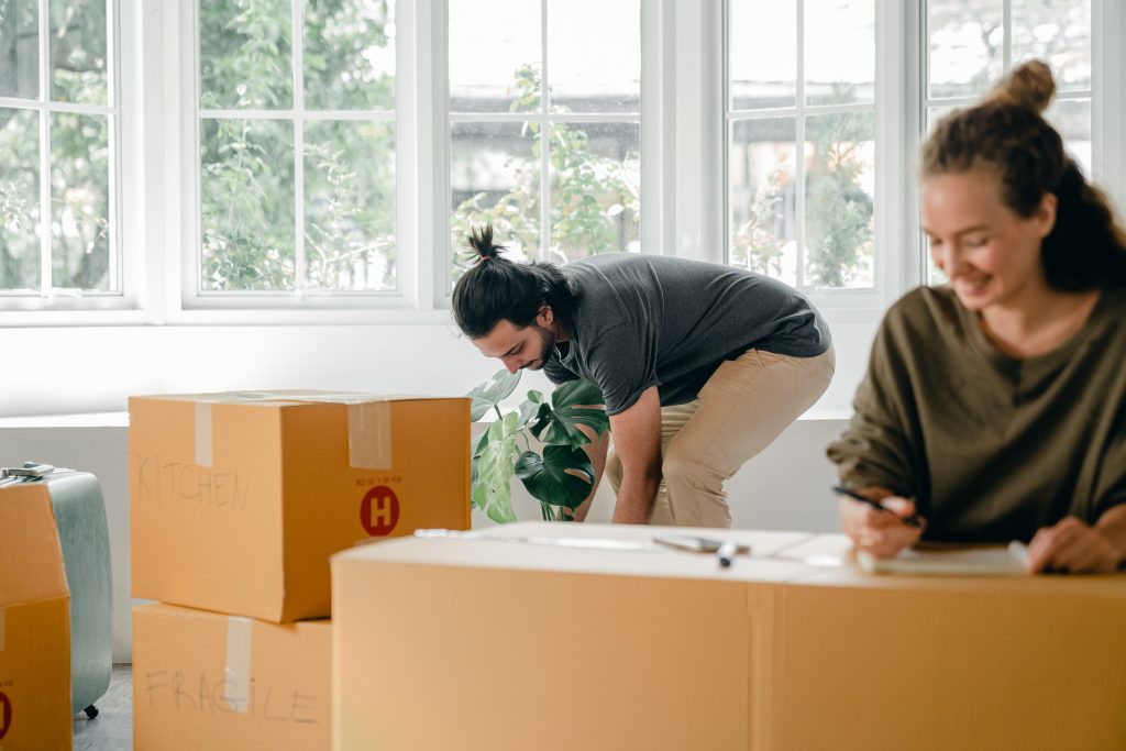 People packing boxes for moving because of moving tips