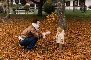 Man playing with a baby in one of the cheapest places to live in Canada with the best quality of life in 2022
