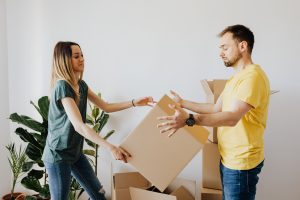 couple learning how to pack a moving truck