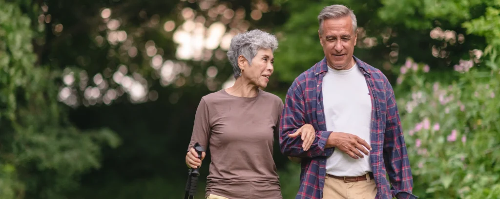 Senior couple enjoying a peaceful day outdoors in Saint-François, Laval, Quebec, surrounded by greenery.