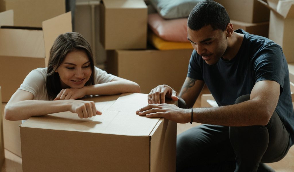 11 Essential Moving Day Tips and Hacks Couple inspect moving box because of moving tip